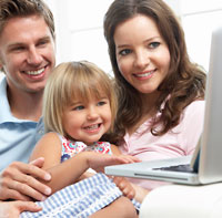 family looking at laptop